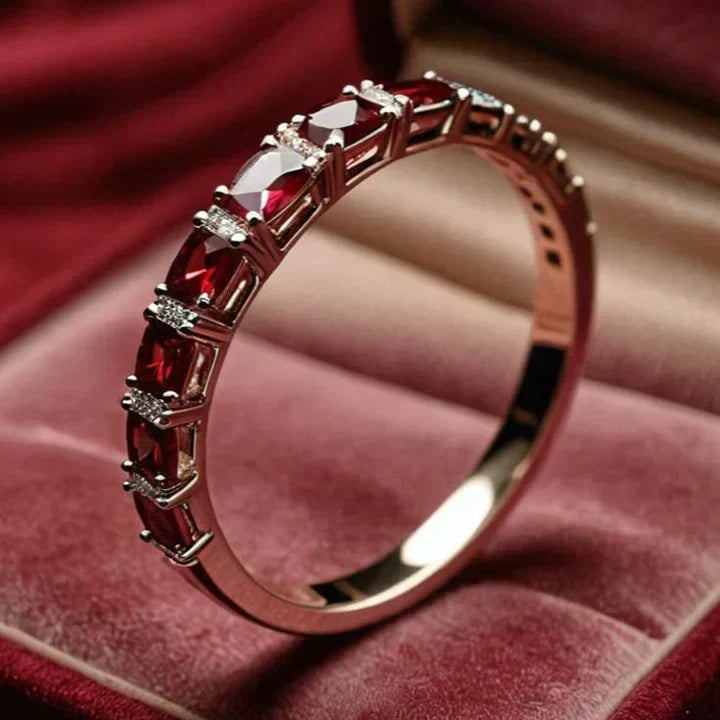 Gold ring adorned with crimson crystal details