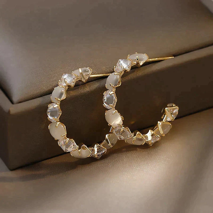 Chic Gold Earrings Adorned with White Opal and Crystal Details